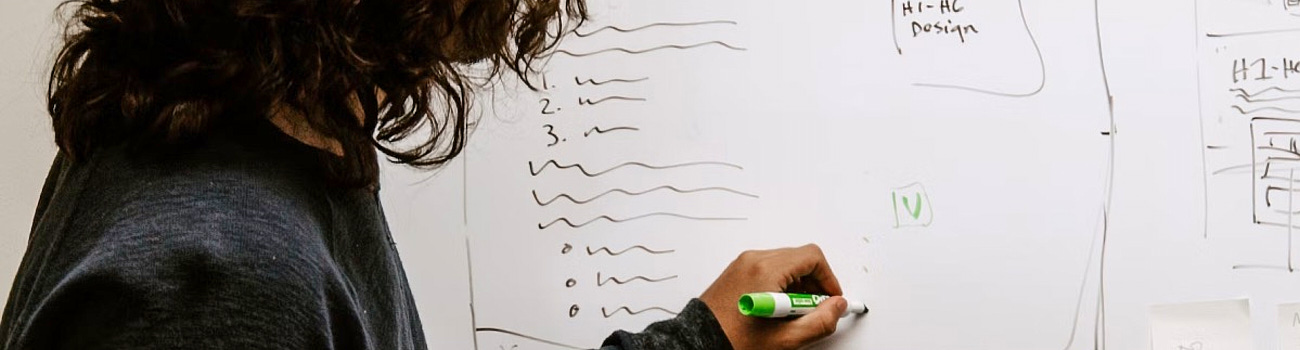 image of woman writing on a whiteboard